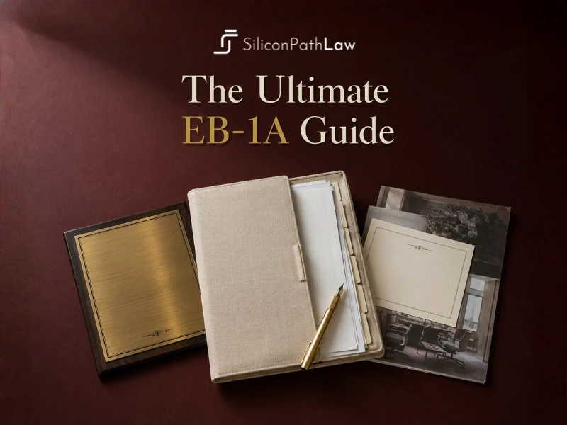 The Ultimate EB-1A Guide: a leather folio, fountain pen and engraved keepsakes on an oxblood desk